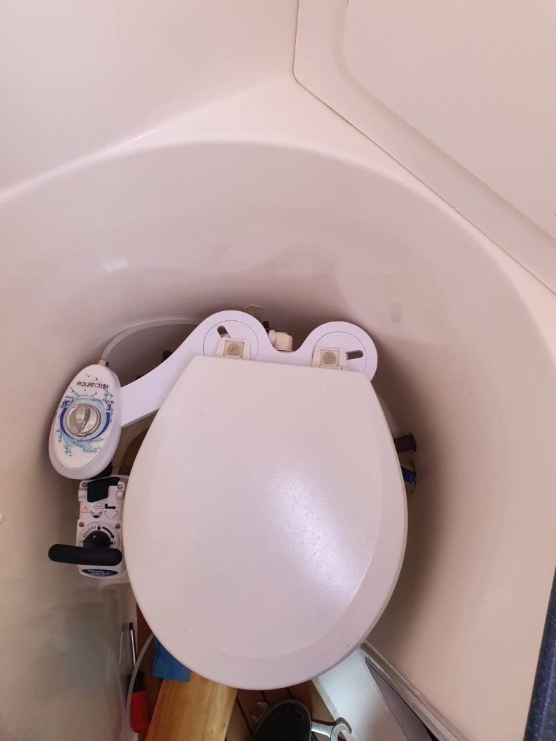 Maro D’Italia CH10 cold water bidet attachment fitted to a marine toilet on a sailboat