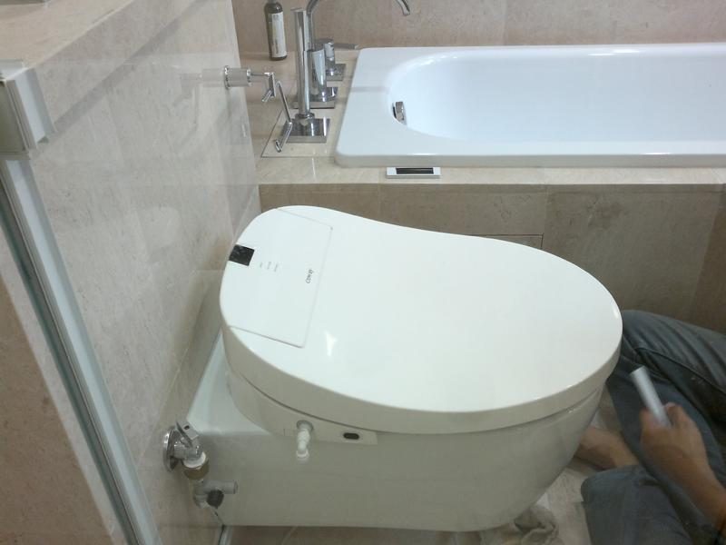 Coway BA13-BE bidet seat installed on a wall-hung toilet pan